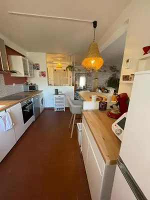 a kitchen with white cabinets and a counter top at En Provence chez Valérie in Cavaillon