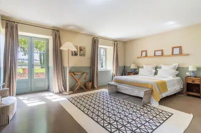 a large bedroom with a bed and a window at Les Deux Mas in Lagnes