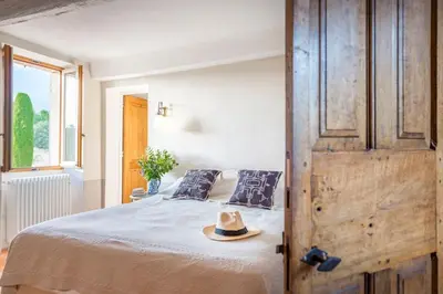 a bedroom with a bed with a hat on it at Maison Sebastien in Saint-Michel-lʼObservatoire