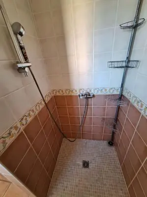 a bathroom with a shower with a tiled floor at Maison en Provence avec jacuzzi in Peyrolles-en-Provence
