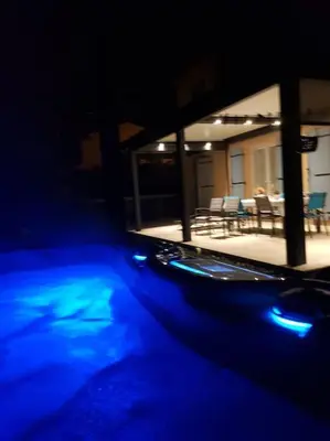 a view of a house with blue lights in the dark at Maison en Provence avec jacuzzi in Peyrolles-en-Provence