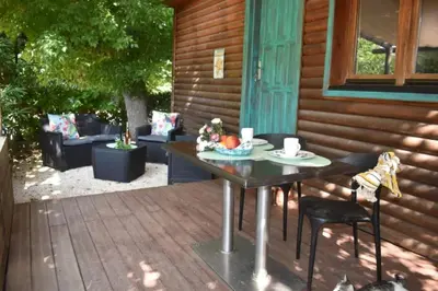 a table and chairs on a porch with a table at Camping 4 étoiles - Piscine - eehf0d in Noves