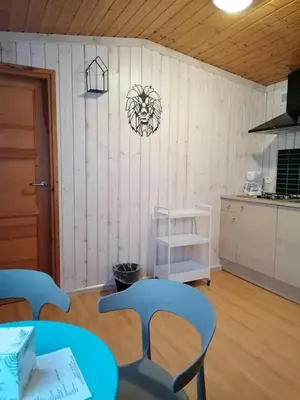 a room with a table and chairs and a kitchen at Camping 4 étoiles - Piscine - eehf0d in Noves