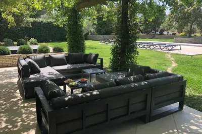 two leather couches and a table in a yard at Villa Oasis Luxury and Relaxation in Provence in Lambesc