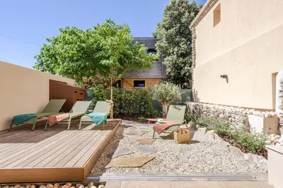 a garden with chairs and a wooden deck at KM2 in Bédoin