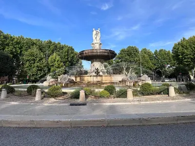 a fountain with a statue in the middle of a park at Charmant studio le clos d'Aix parking privé gratuit et piscine in Aix-en-Provence