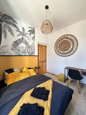 a bedroom with a bed and a pendant at Le Platane Maison climatisée avec piscine in Monteux