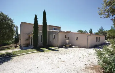 a house with cypress trees in front of it at Awesome Home In Joucas With Kitchen in Joucas