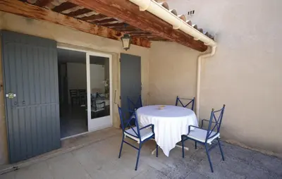 a table and chairs sitting on a patio at Awesome Home In Joucas With Kitchen in Joucas