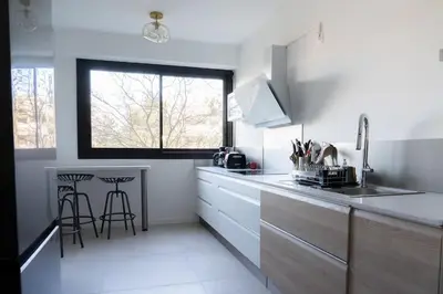 a white kitchen with a counter and a window at T3 Centre ville Aix-en-Provence in Aix-en-Provence