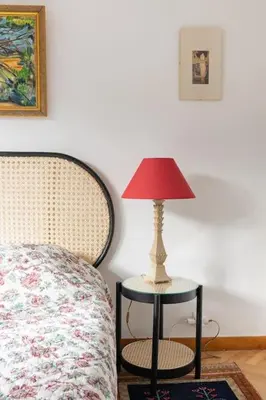 a lamp sitting on a table next to a bed at T3 Centre ville Aix-en-Provence in Aix-en-Provence