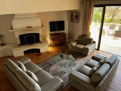 a living room with a couch and a fireplace at Domaine des Figons in Éguilles