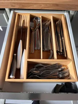 a drawer full of utensils in a cabinet at Le l'islois- Park&Piscine in LʼIsle-sur-la-Sorgue