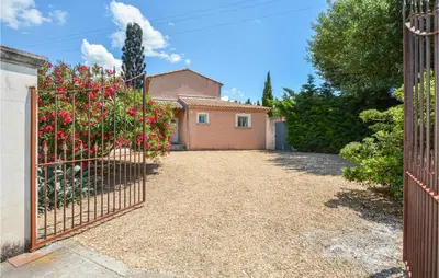 a gate to a house with a driveway at Nice Home In Eyguieres With Wifi in Eyguières