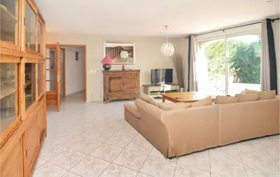 a living room with a couch and a table at Nice Home In Eyguieres With Wifi in Eyguières