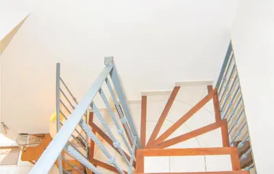 a staircase in a room with a white wall at Amazing Home In Saint Remy De Provence in Saint-Rémy-de-Provence