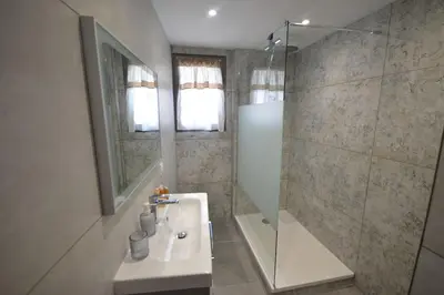 a bathroom with a sink and a shower at La maison d'Anthonie, Roussillon in Roussillon