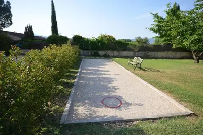 a path with a bench next to a park at La maison d'Anthonie, Roussillon in Roussillon