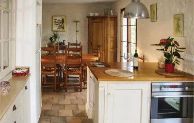 a kitchen with a table and a dining room at La Maoure in Robion en Luberon