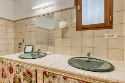 a bathroom with two sinks and a mirror at La Maison du Chapelier in Fontaine-de-Vaucluse