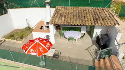 an overhead view of a house with a table and an umbrella at La Maison du Chapelier in Fontaine-de-Vaucluse