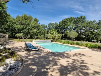 a swimming pool with two lounge chairs in a yard at Mas Libertino - Villa avec piscine & jacuzzi in Pernes-les-Fontaines