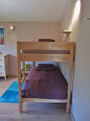 a bunk bed in a room with a purple mattress at appartement T3 dans propriété de 5000m2 avec piscine in Venelles