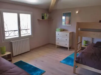 a bedroom with a bunk bed and a dresser at appartement T3 dans propriété de 5000m2 avec piscine in Venelles