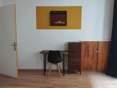 a desk and a chair next to a wall at Appartement en plein centre. in Carpentras