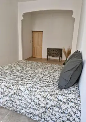 a bedroom with a bed with a pillow on it at Appartement de caractère - CARPENTRAS - Rendez-vous en Provence in Carpentras