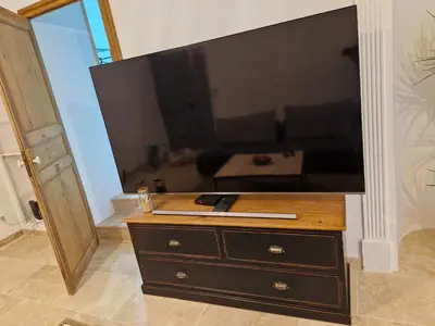 a dresser with a large television on top of it at Appartement de caractère - CARPENTRAS - Rendez-vous en Provence in Carpentras