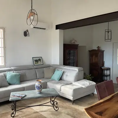a living room with a couch and a table at Lou Jasset in Cabrières-dʼAigues