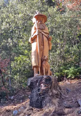 a statue of a man standing on top of a tree stump at Chalet du Mont Ventoux - Rendez-vous en Provence in Bédoin