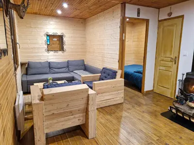 a living room with a blue couch in a cabin at Chalet du Mont Ventoux - Rendez-vous en Provence in Bédoin