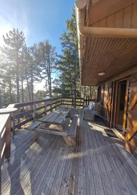 a wooden deck with benches on the side of a building at Chalet du Mont Ventoux - Rendez-vous en Provence in Bédoin