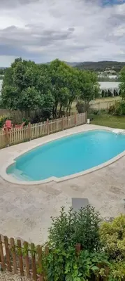 a large blue swimming pool in a yard at Chambres d'Hôtes et Suite, Domaine Les Peupliers, Lagnes in Lagnes