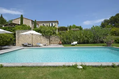 a swimming pool in the backyard of a house at Mas des Papillons Gordes in Gordes