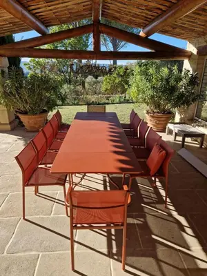 a wooden table and chairs on a patio at Mas des Papillons Gordes in Gordes