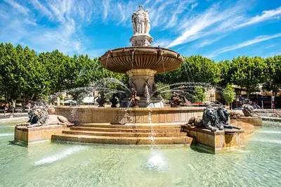 a fountain in a park on a sunny day at Appartement de Charme in Aix-en-Provence