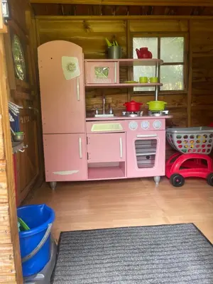 a pink toy kitchen with a pink refrigerator at Appartement in Caumont-sur-Durance
