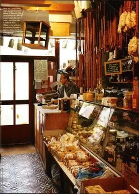 a man sitting at a counter in a store at plein coeur de BANON in Banon