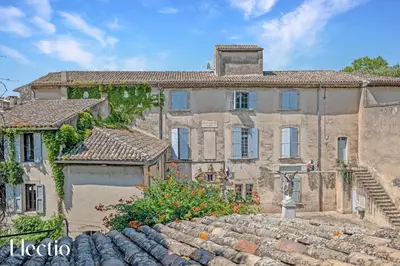 an old stone house with a staircase in front of it at Maison Alena Lourmarin Main Square in Lourmarin