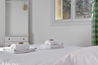 a white bed with towels on top of it at Maison Alena Lourmarin Main Square in Lourmarin