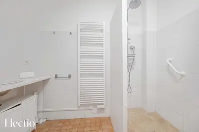 a white bathroom with a shower and a sink at Maison Alena Lourmarin Main Square in Lourmarin