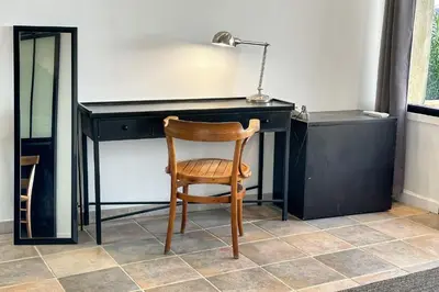 a desk with a chair and a lamp on it at Appartement I Bastide La Gravière I Electio in Lourmarin