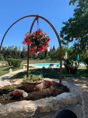 a flower garden with a hanging basket of flowers at La Miougrano in Plan-dʼOrgon