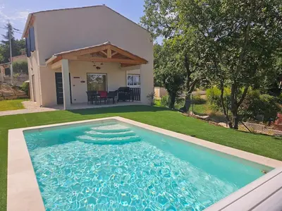 a swimming pool in front of a house at Maison en Provence avec piscine in Sainte-Tulle