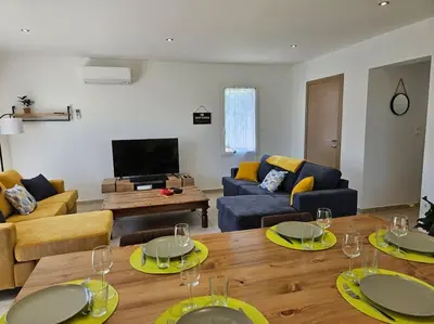 a living room with couches and a table with wine glasses at Maison en Provence avec piscine in Sainte-Tulle