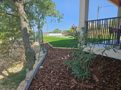 a garden in front of a house with a fence at Maison en Provence avec piscine in Sainte-Tulle