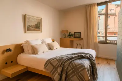 a bedroom with a large bed and a window at Le Saint Hubert in Saint-Saturnin-les-Apt